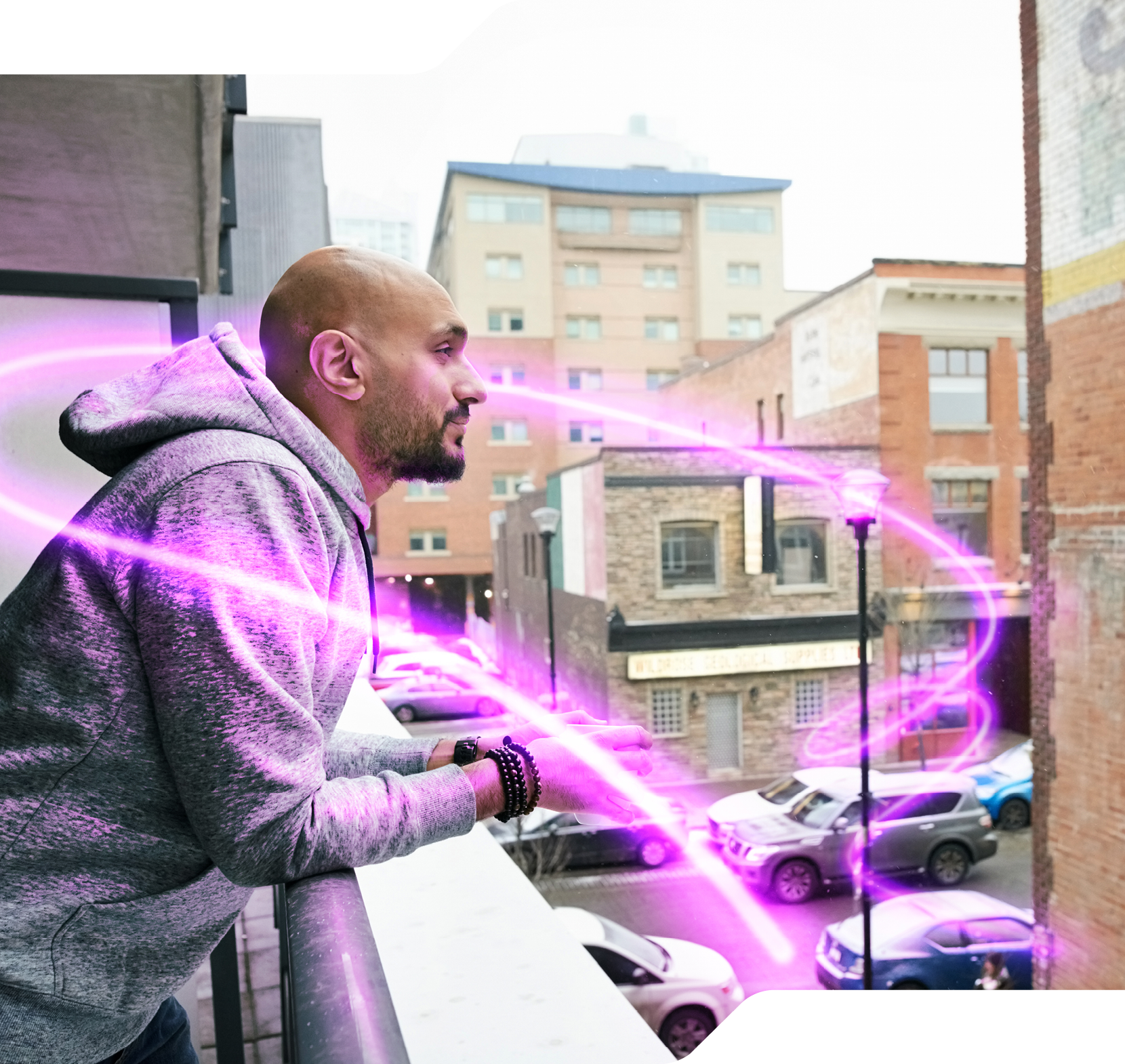 Side view of young man standing in the balcony with cup of coffee