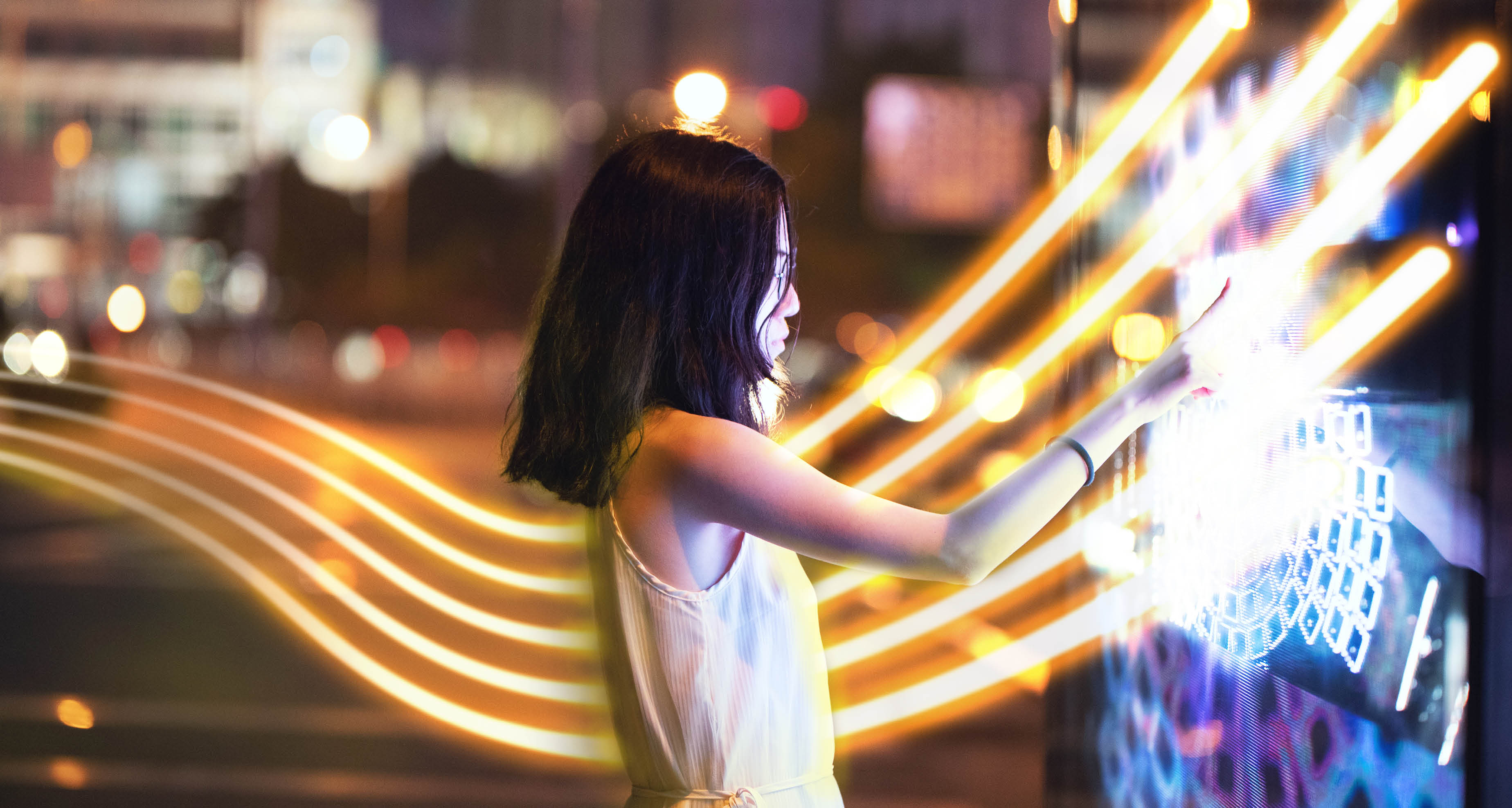 Young female using touch screen on the street