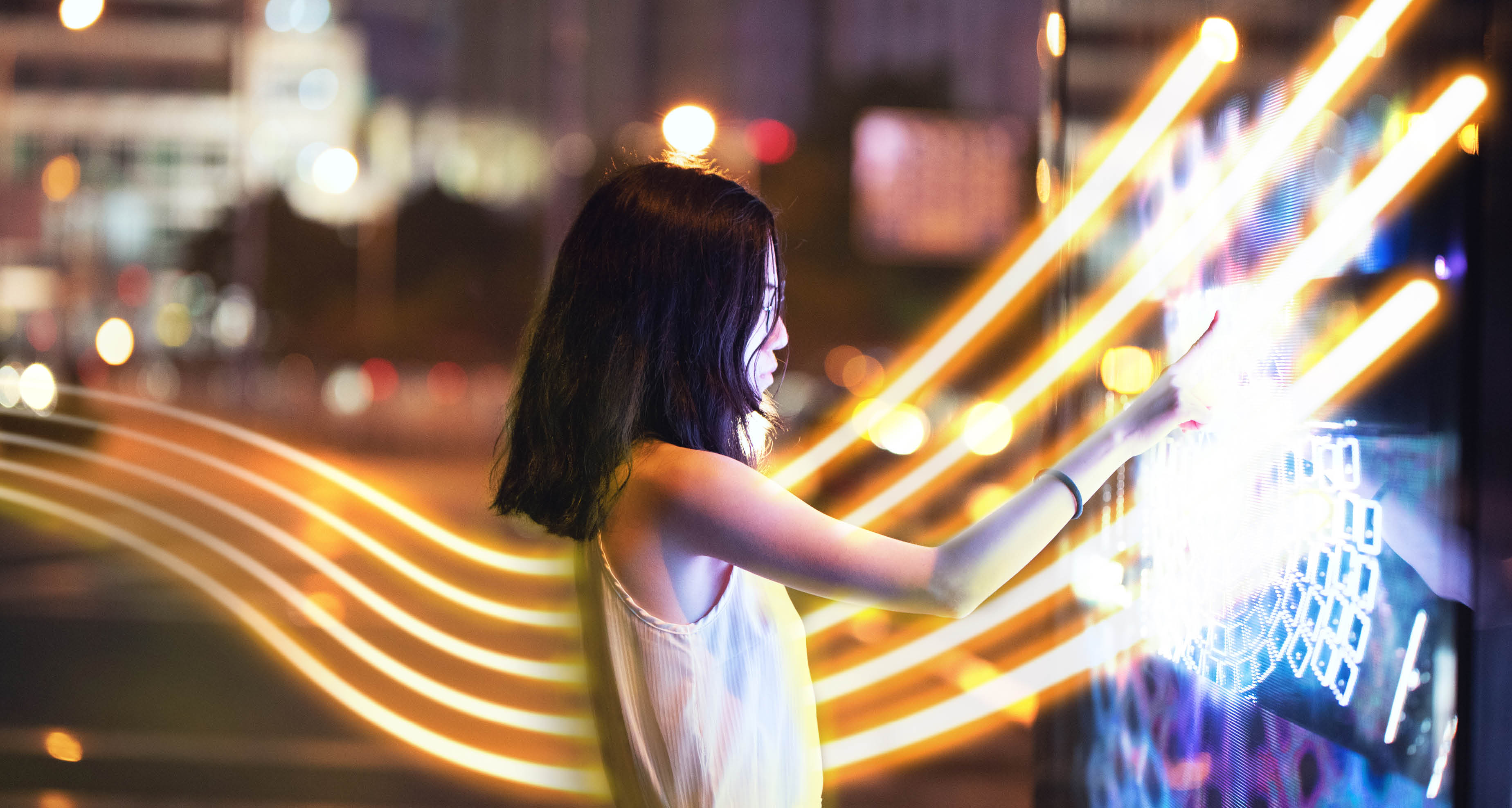 Young female using touch screen on the street
