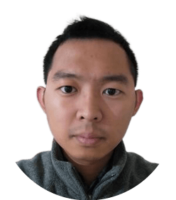 A man with short black hair and a gray sweater. Description generated by AI