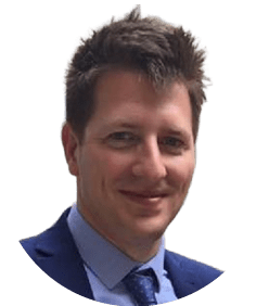 A man wearing a blue suit and a blue tie. Description generated by AI