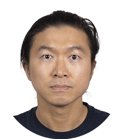 A man with black hair and a blue shirt. Description generated by AI