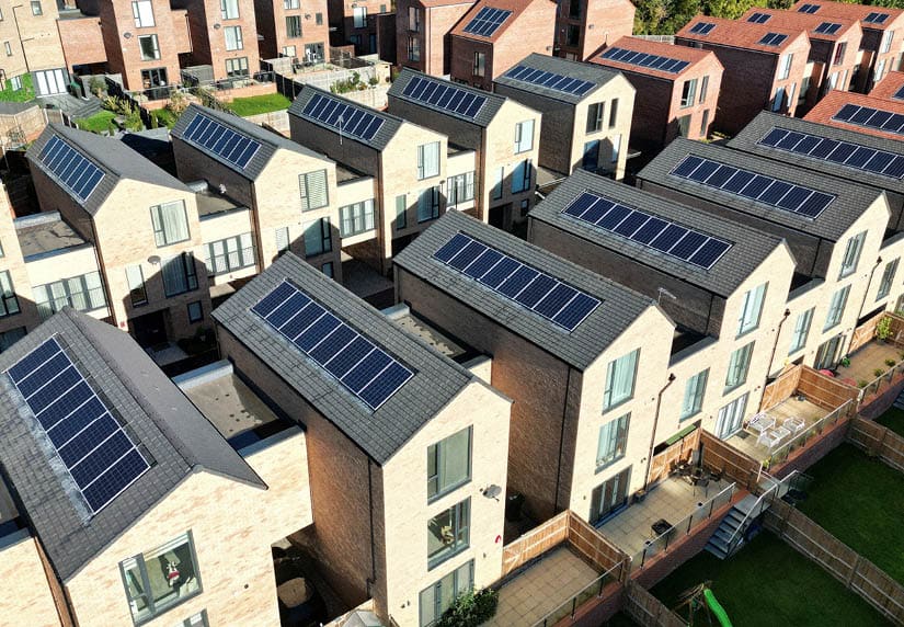 Aerial view of a newly built housing development with solar panels installed on the rooftops